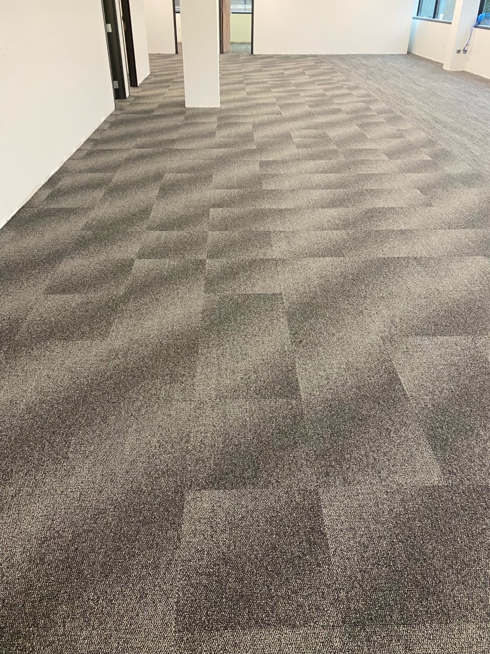 Open office with patterned carpet tile and glass partitions