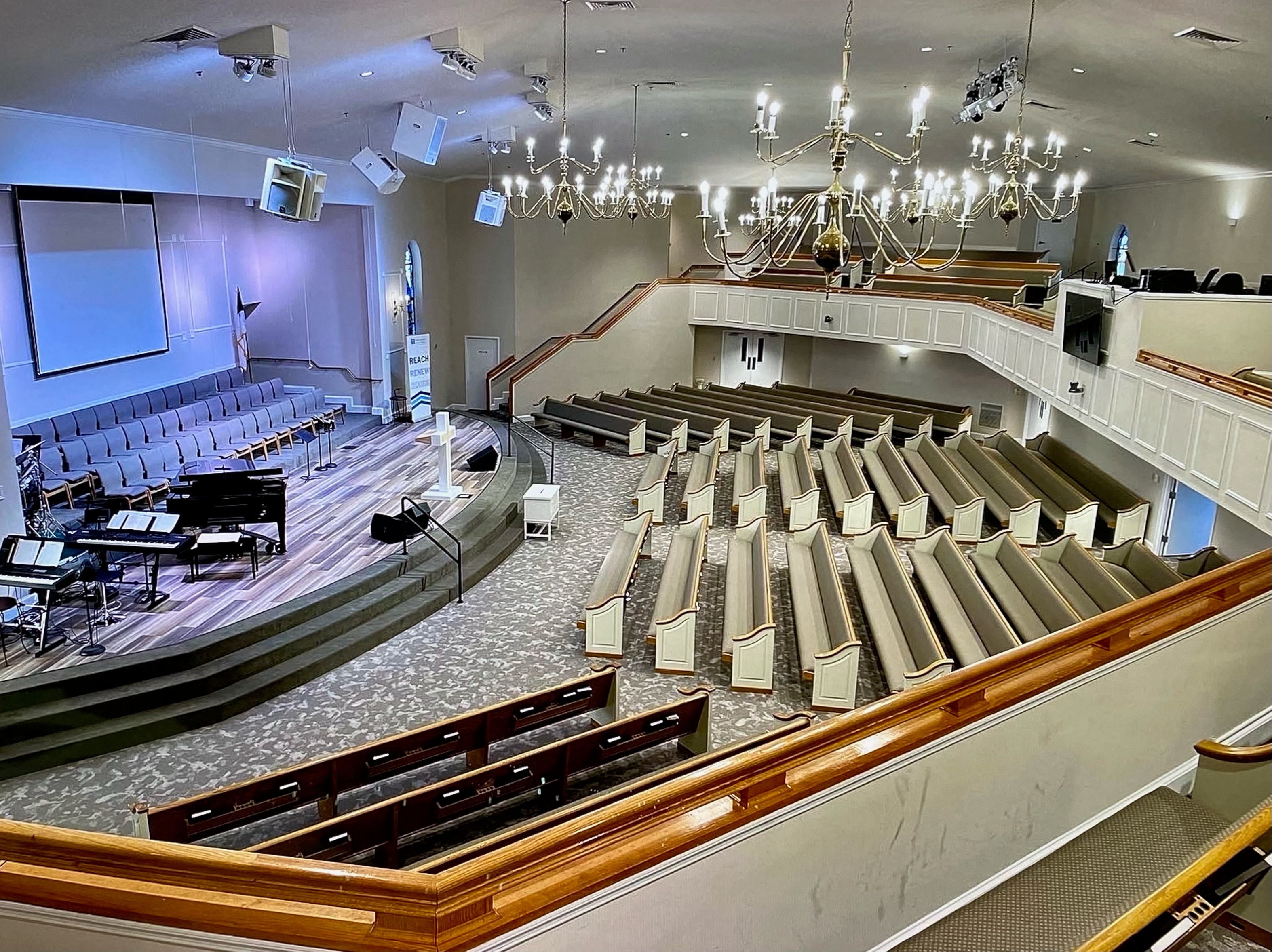 Full sanctuary view with chandeliers and balcony