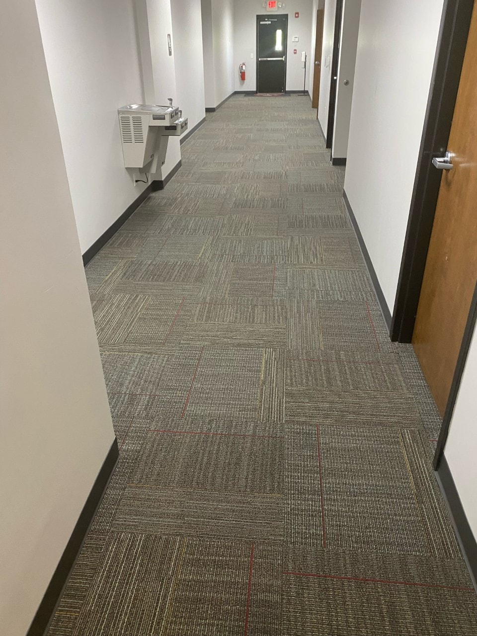 Commercial hallway with carpet tile and water fountain